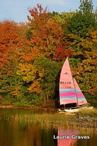 Colorful boat by colorful leaves on Maranacook Lake