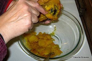 Scooping and mashing squash