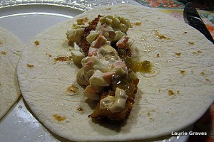 A fish taco, ready to be eaten