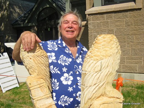 Mike Sienko, a library volunteer, posing with the unfinished sculpture.