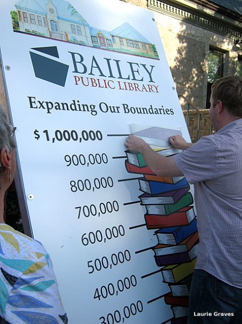Richard Fortin, the library director, places the last book