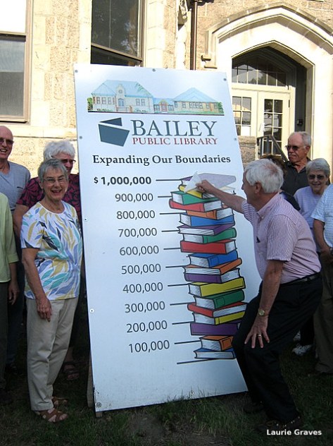 Roger Lajeunesse peels the sticker