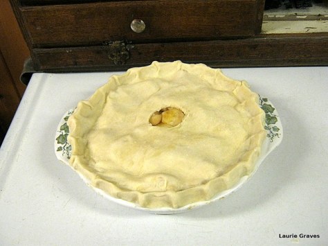 The pie with crimped edges and a hole in the middle